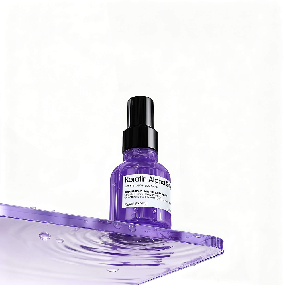 Keratin hair serum in a purple 50ml spray bottle on a glossy surface, professional hair care